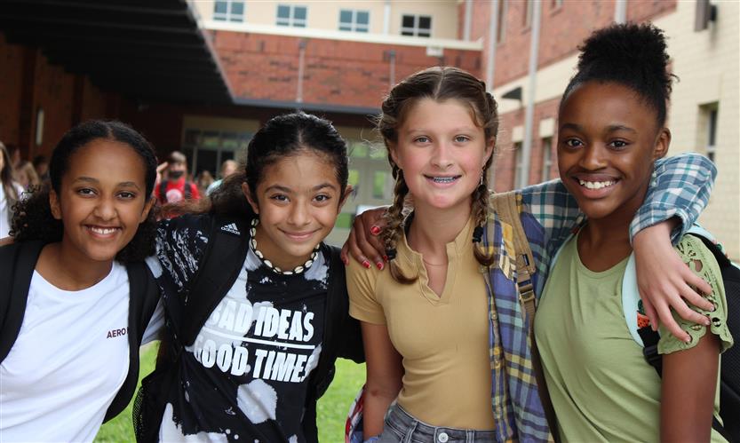 A group of students smiles